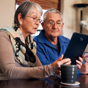 Two seniors looking at a tablet